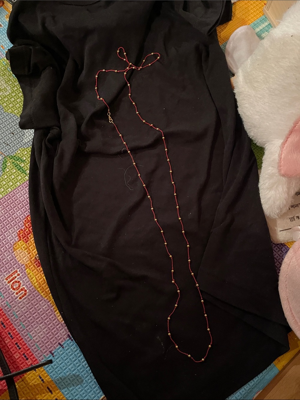 Red thread with gold balls